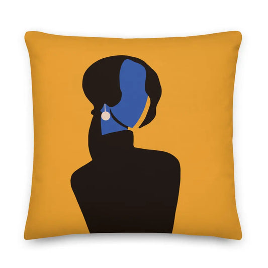 A 22 x 22 abstract decorative pillow featuring a minimalist feminine silhouette in deep black with a vivid cobalt blue face and pearl earring, set against a warm golden background. The modern composition blends elegance, mystery, and contemporary gallery-inspired design. White background.