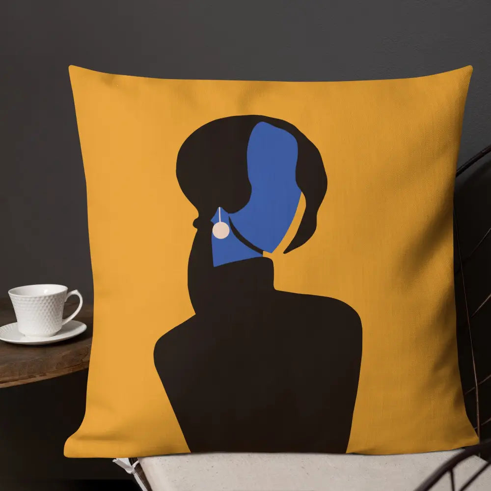 An abstract decorative pillow featuring a minimalist feminine silhouette in deep black with a vivid cobalt blue face and pearl earring, set against a warm golden background. The modern composition blends elegance, mystery, and contemporary gallery-inspired design.